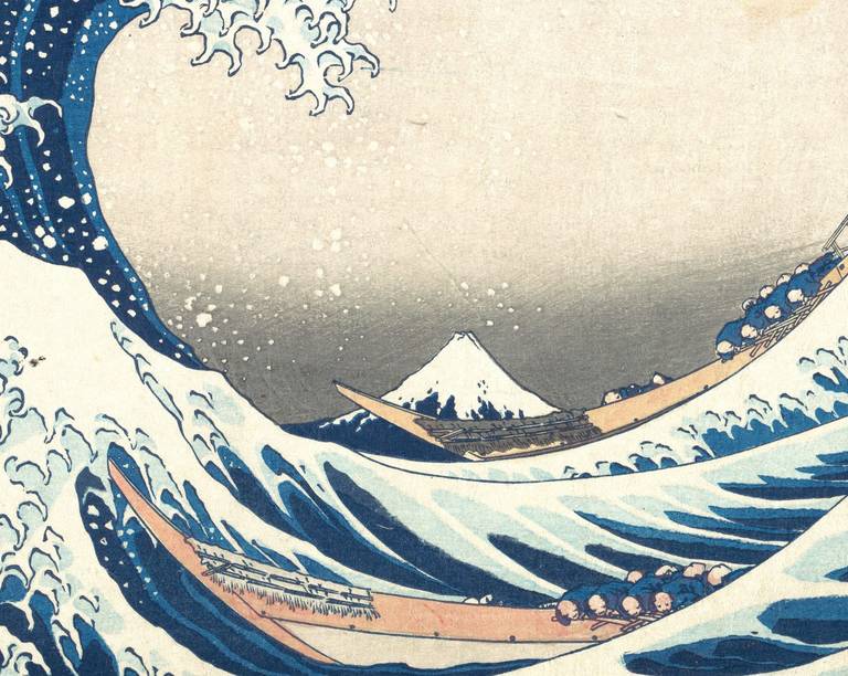 Detail of The Great Wave showing Mount Fuji small in the distance behind the trough of the wave, with two boats of rowers